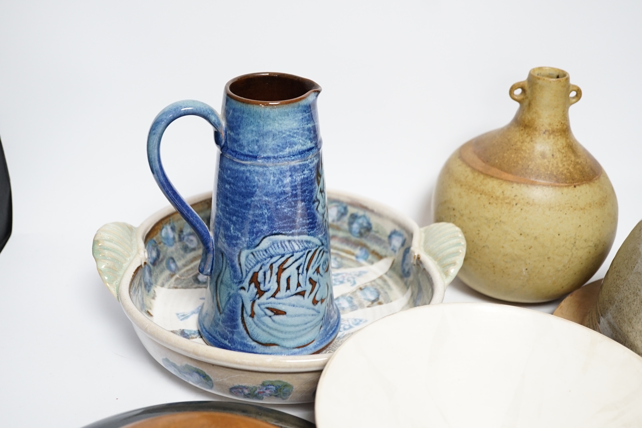 Eight studio pottery items including a cylindrical pot by Mary Rich, a Brenda Wright serving dish, a Tony Gant vase, etc.